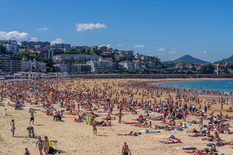 The curving sweep of La Concha bay and beach at San Sebastián seen from the hillside