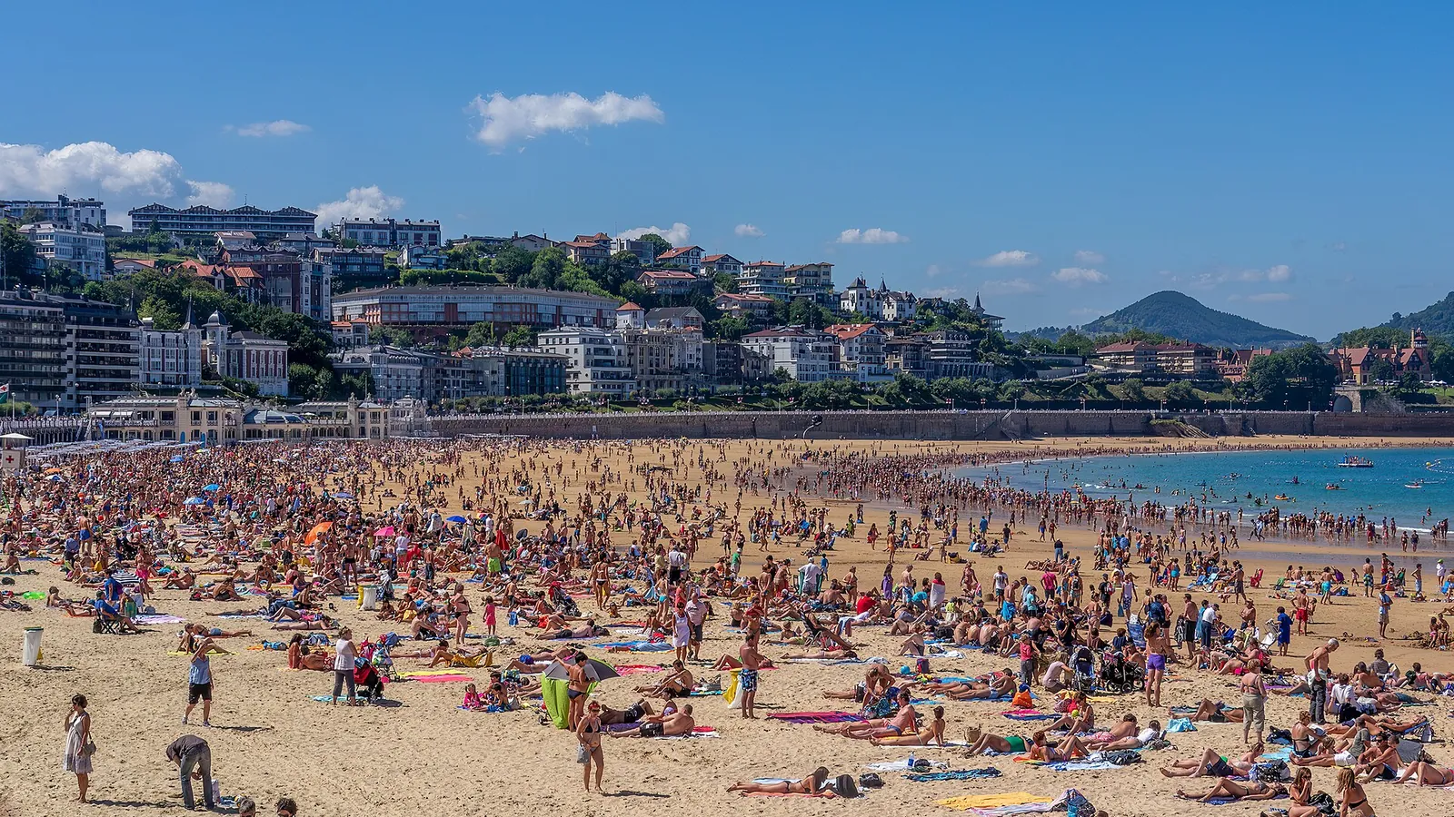 The curving sweep of La Concha bay and beach at San Sebastián seen from the hillside