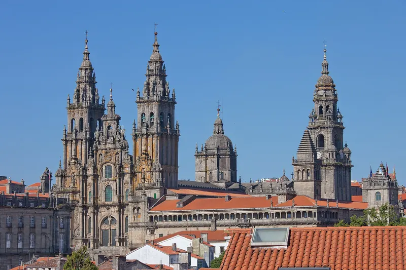 The baroque west facade of Santiago de Compostela cathedral rising above its granite square