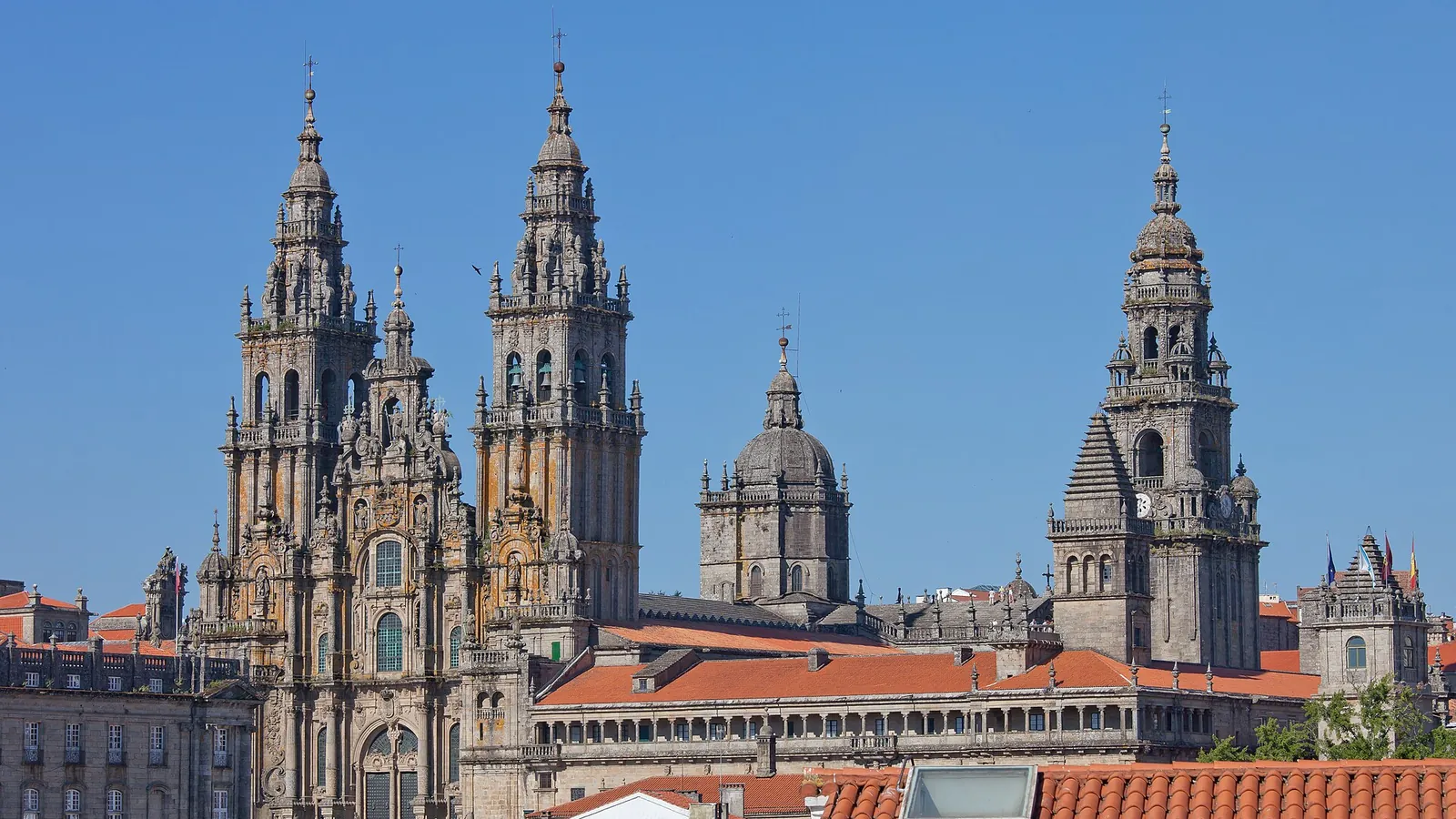 The baroque west facade of Santiago de Compostela cathedral rising above its granite square