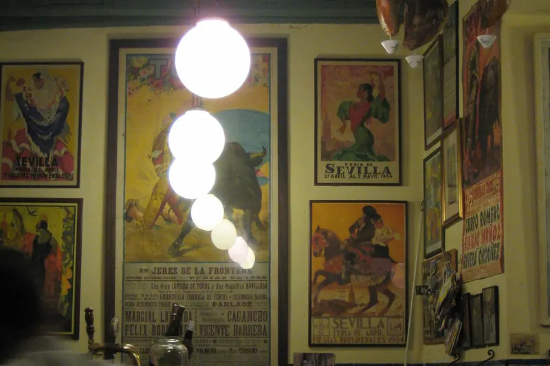 A traditional tapas bar hung with hams and posters