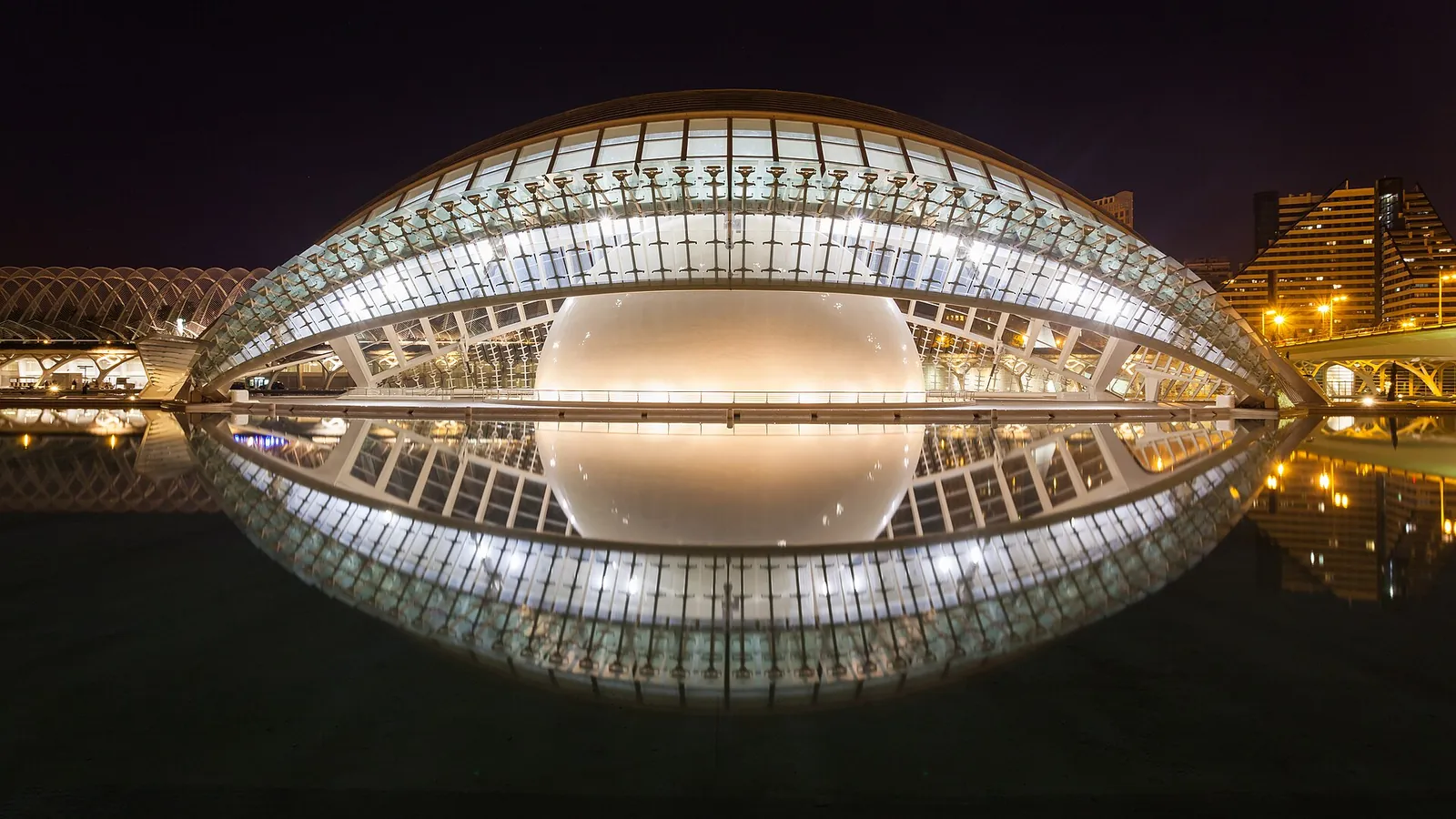 The eye-shaped Hemisfèric building reflected in a pool at the City of Arts and Sciences in Valencia