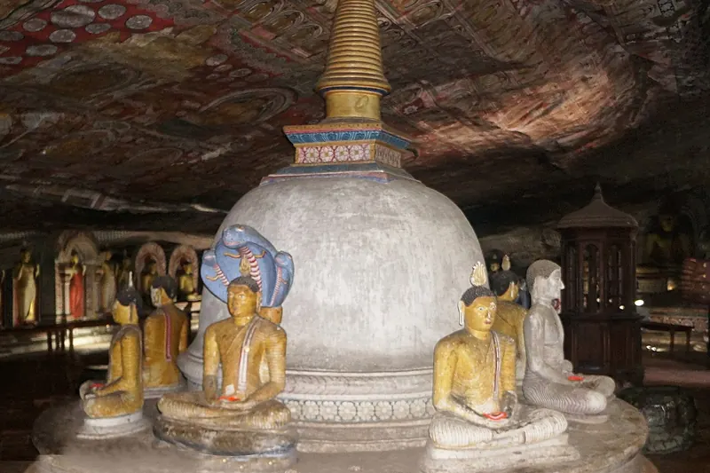 A Buddha statue sheltered by the cobra Mucalinda in Dambulla cave temple