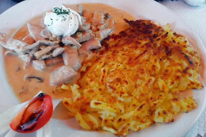 Sliced veal in a creamy mushroom sauce, served Zurich-style