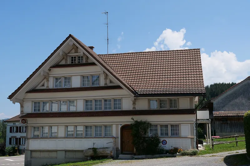 Painted wooden houses lining a village street in Appenzell