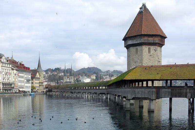 The wooden Chapel Bridge and stone water tower crossing the Reuss river in Lucerne