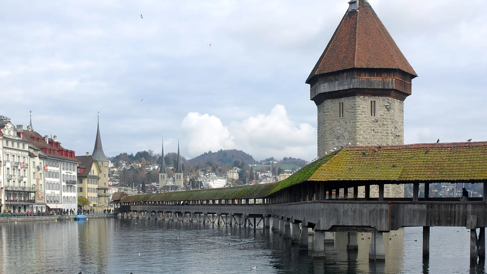 The wooden Chapel Bridge and stone water tower crossing the Reuss river in Lucerne