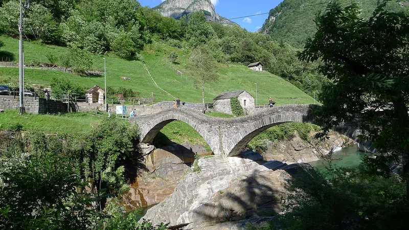 The Ponte dei Salti stone bridge over the clear green Verzasca river