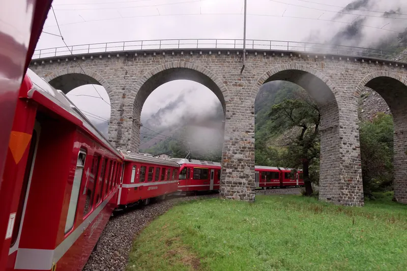 The Brusio spiral viaduct curving through green fields