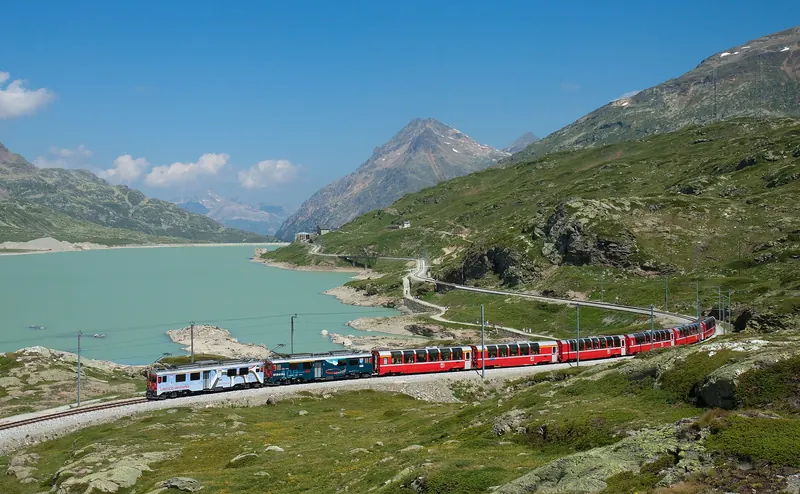 The Bernina Express beside the milky-white Lago Bianco
