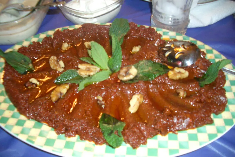 A bowl of muhammara, a red dip of roasted peppers and walnuts