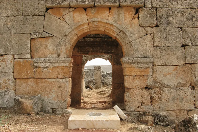 A ruined stone gateway in the abandoned Byzantine village of Serjilla, photographed in 2008, before the war