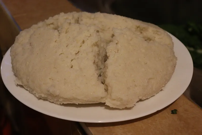 A mound of ugali, a stiff maize porridge, on a plate