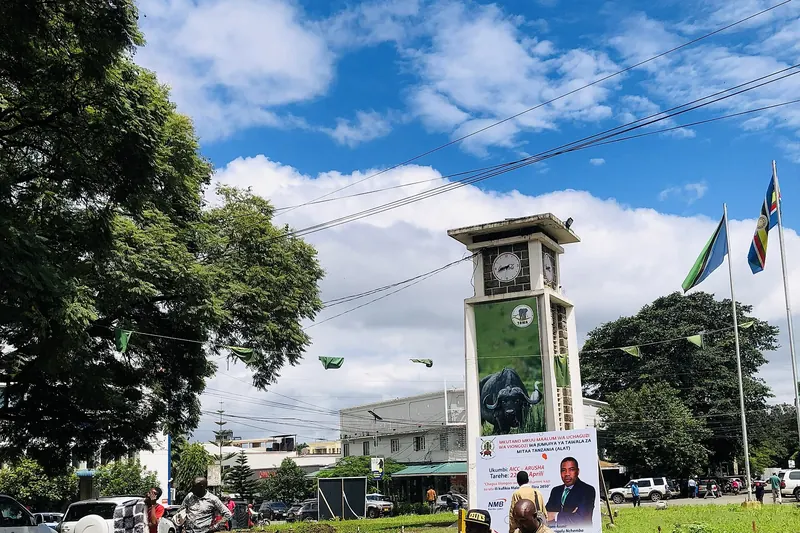 The Arusha clock tower with a motorbike taxi