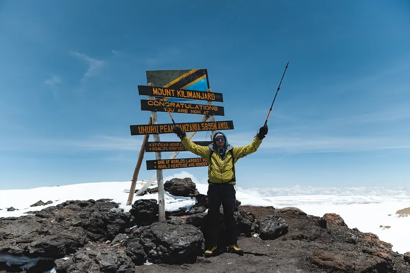 Hikers on Uhuru Peak, the summit of Mount Kilimanjaro