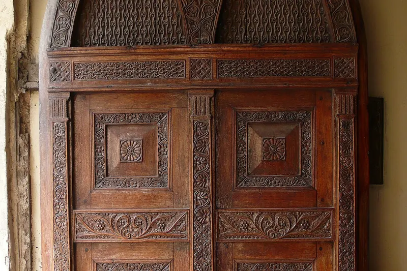 An ornate carved wooden door in Stone Town