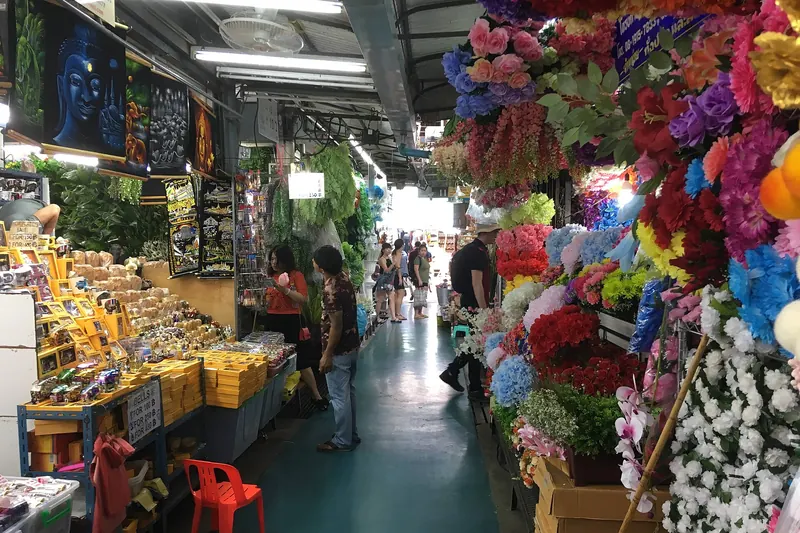 Stalls and shoppers at Chatuchak Weekend Market in Bangkok