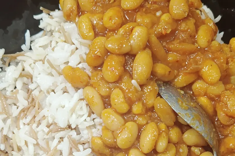 White beans in tomato sauce served over rice