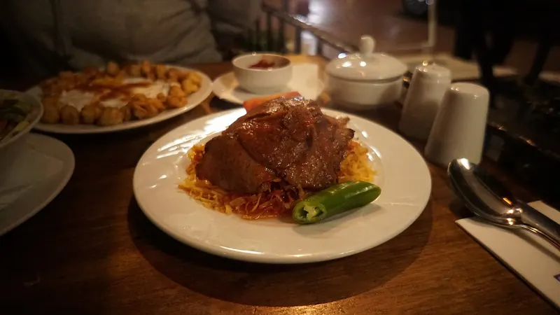 Çökertme kebabı — matchstick potatoes under meat and yoghurt