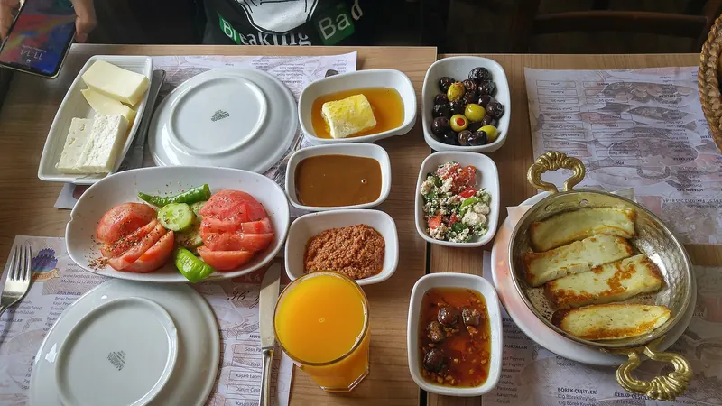 A Turkish breakfast spread of cheese, olives, tomato and preserves