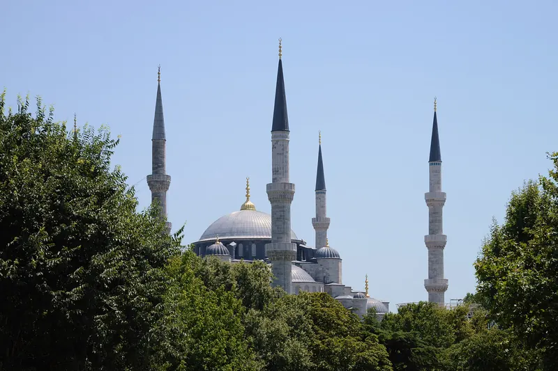 The domes and minarets of Hagia Sophia in Istanbul against a clear sky