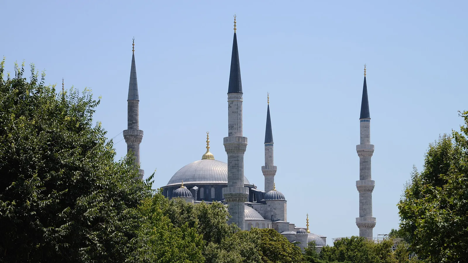The domes and minarets of Hagia Sophia in Istanbul against a clear sky