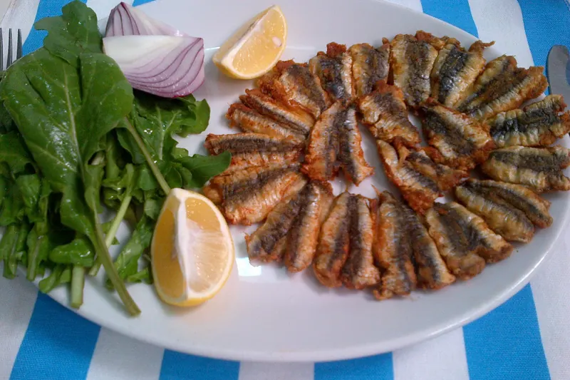 Fried hamsi, the Black Sea anchovy, with rocket and lemon