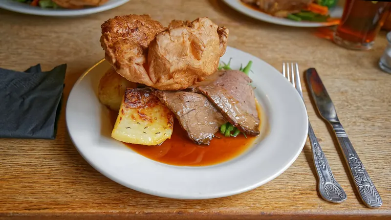 A Sunday roast dinner with lamb, potatoes and vegetables
