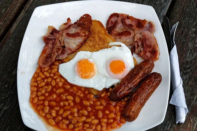 A full English breakfast with eggs, bacon, sausage and beans