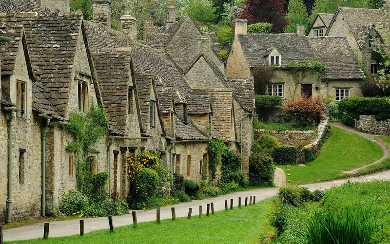 The golden-stone cottages of Arlington Row in the Cotswolds village of Bibury