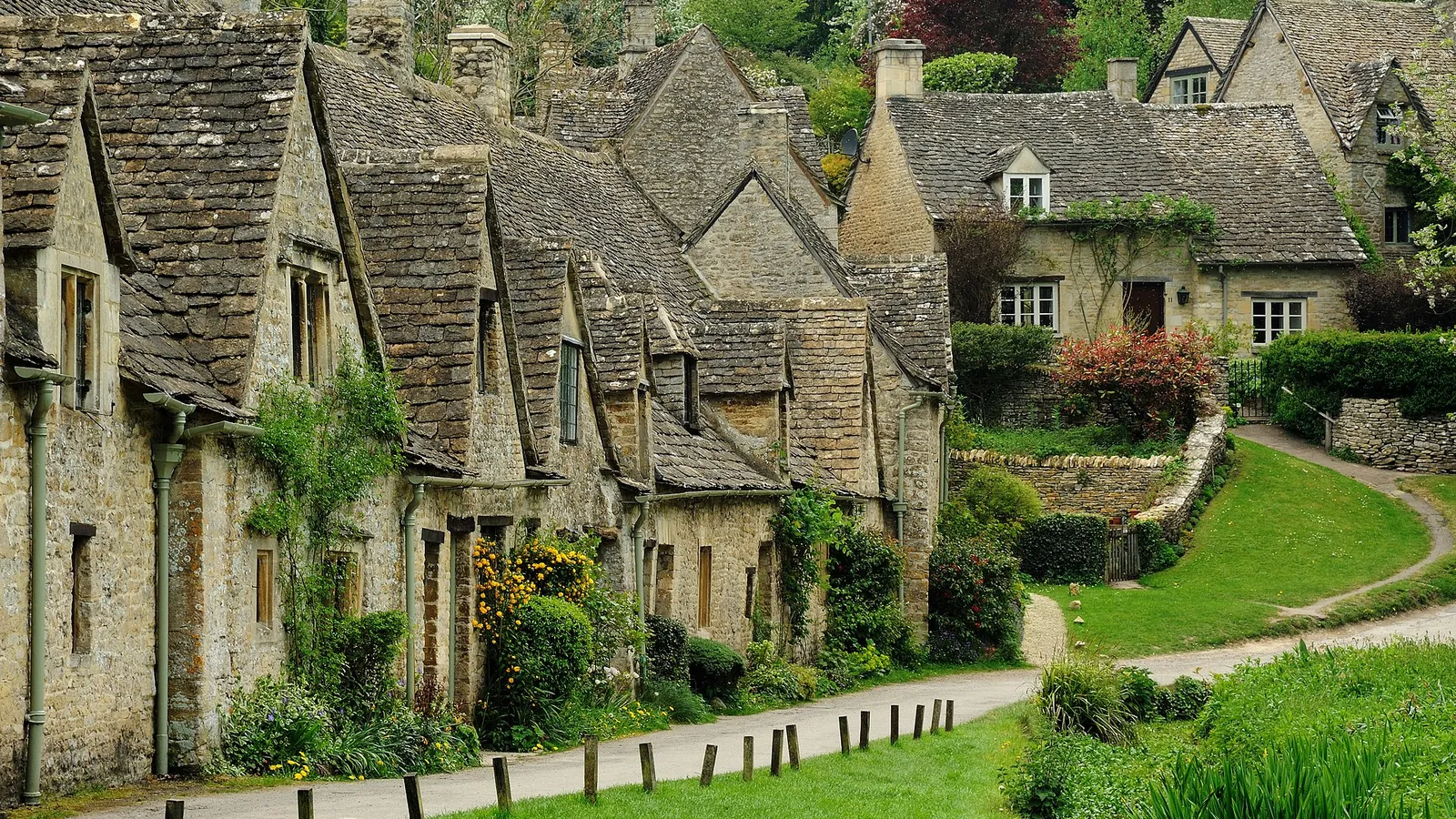 The golden-stone cottages of Arlington Row in the Cotswolds village of Bibury