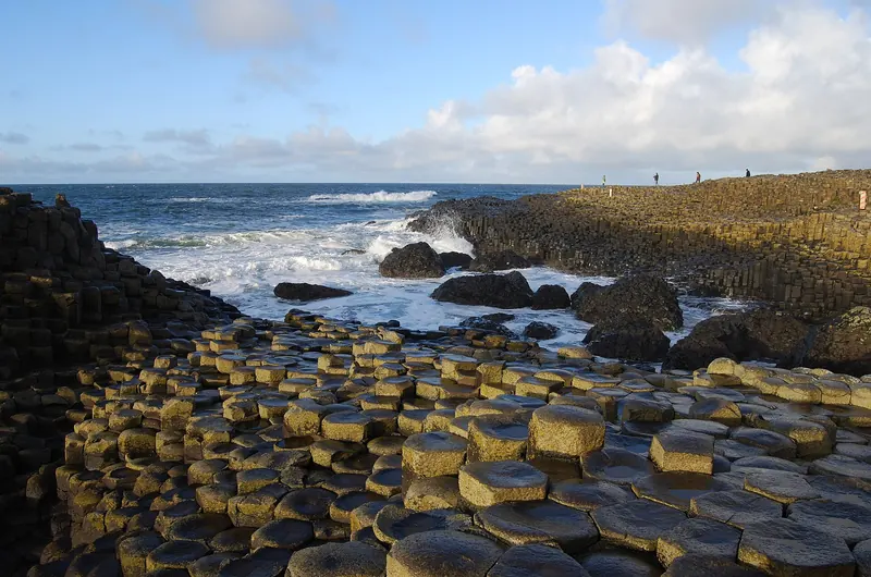 The hexagonal basalt columns of the Giant's Causeway meeting the sea