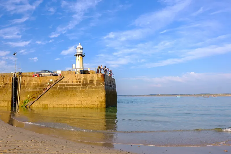 St Ives harbour pier with its lighthouse at low tide