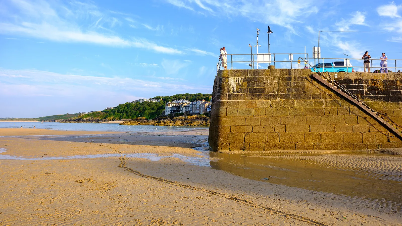 St Ives harbour beach with the pier and town beyond