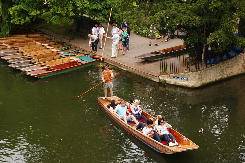 Punts on the River Cam passing beneath the colleges of Cambridge