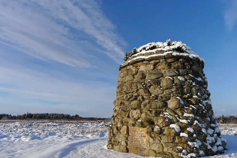 The stone memorial cairn on the open moorland of Culloden Battlefield