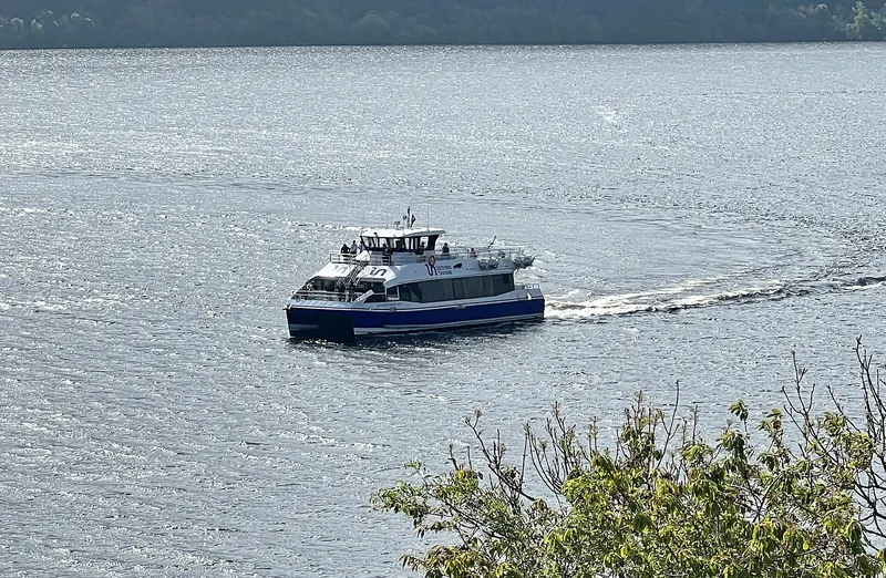 A tour boat crossing the open water of Loch Ness