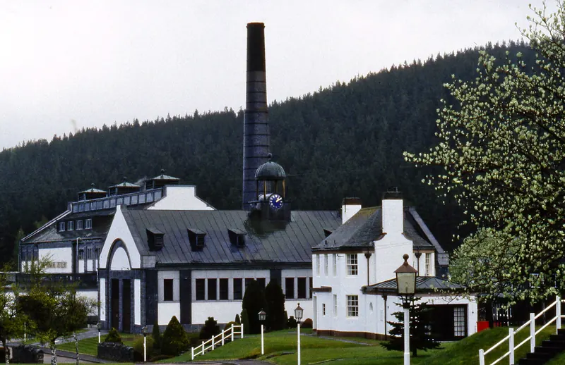 A Speyside whisky distillery building with its tall chimney