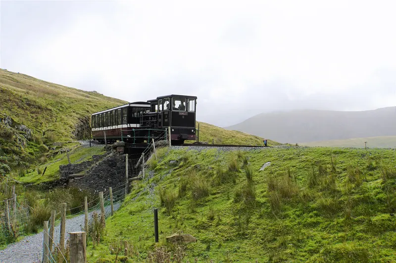 A train on the Snowdon Mountain Railway climbing Yr Wyddfa