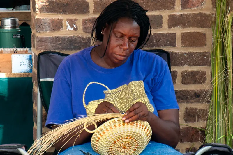 A sweetgrass basket maker at work
