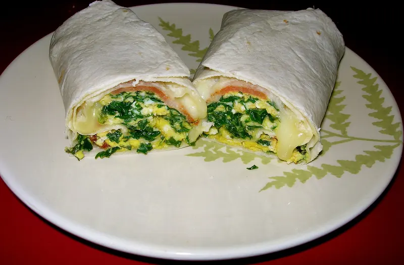 A breakfast burrito wrapped in a flour tortilla