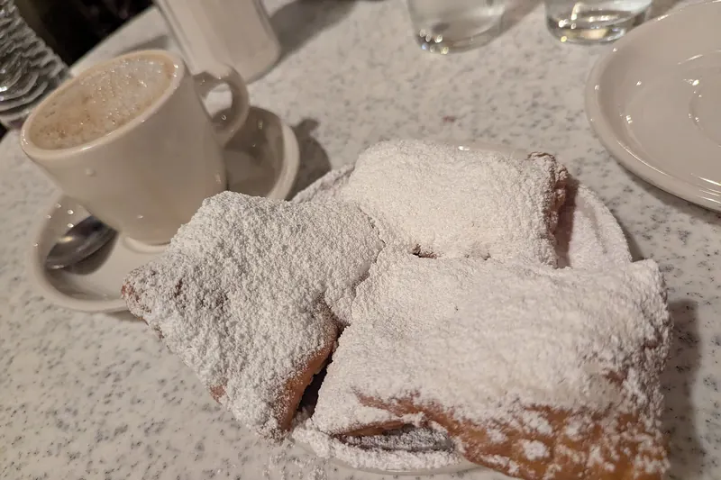Beignets buried in icing sugar at Café du Monde