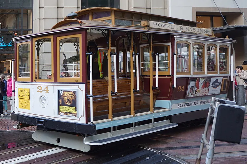 A San Francisco cable car on a city hill