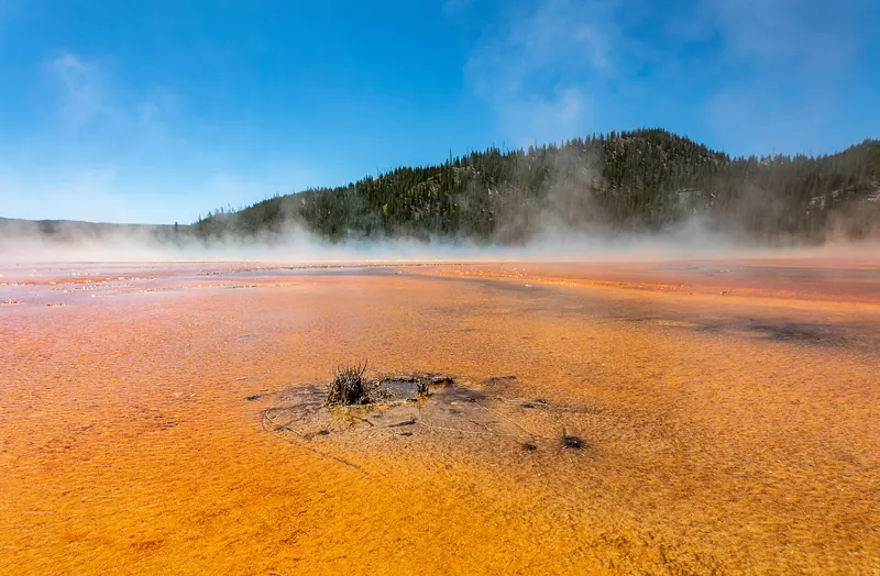 The orange, yellow and deep blue bands of the Grand Prismatic Spring in Yellowstone