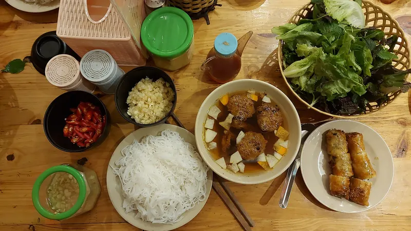 Bun cha with grilled pork patties, rice noodles and herbs in Hanoi