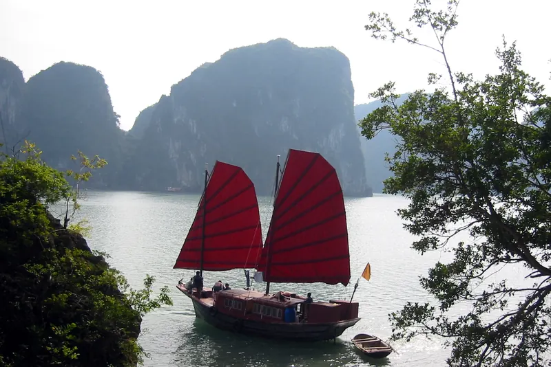 A traditional junk sailing among limestone islands in Ha Long Bay