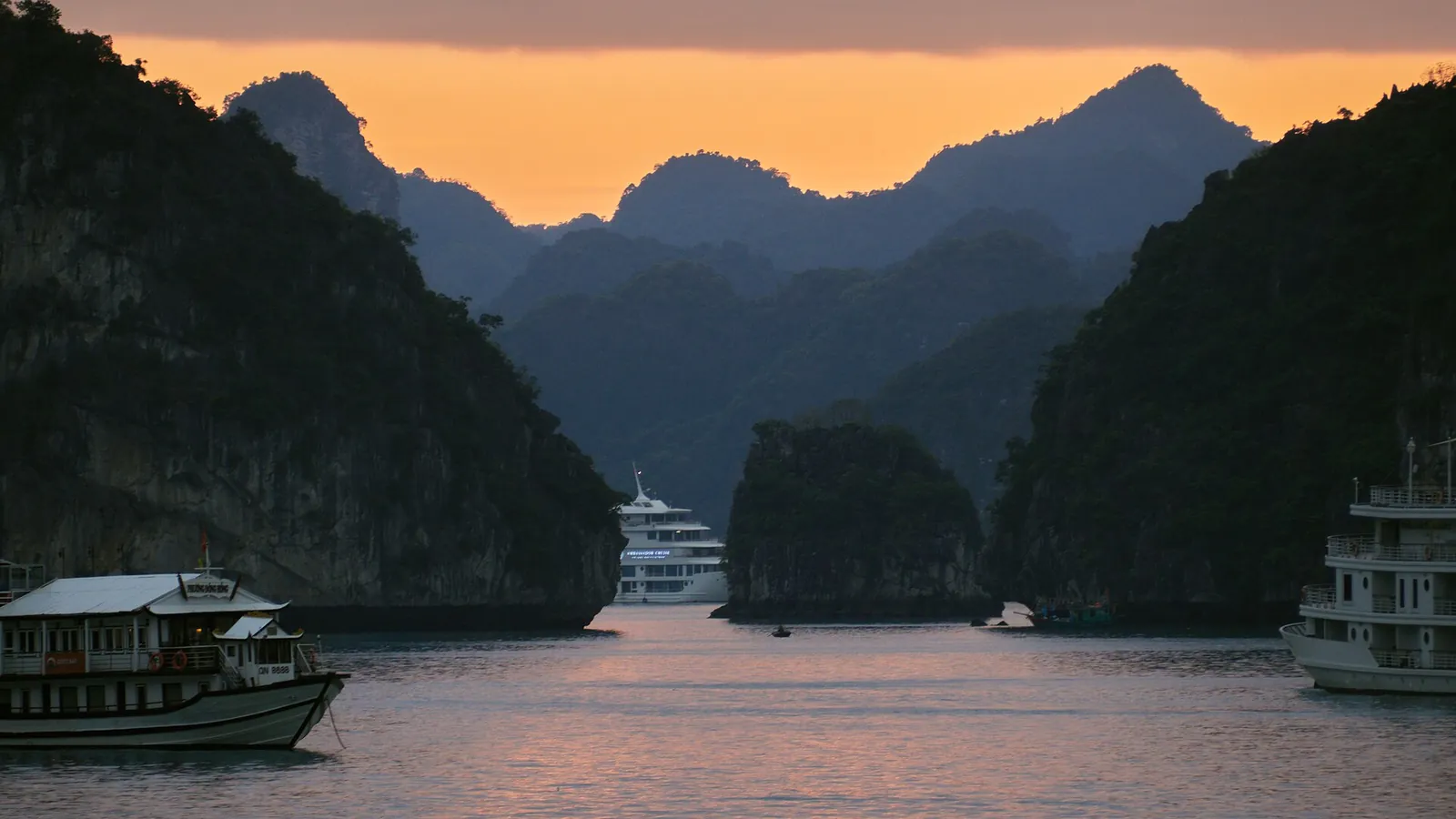 Limestone karst islands rising from the green waters of Ha Long Bay