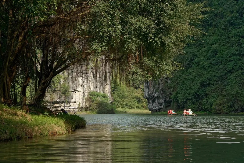 Limestone karst hills and a river at the Trang An Landscape Complex in Ninh Binh