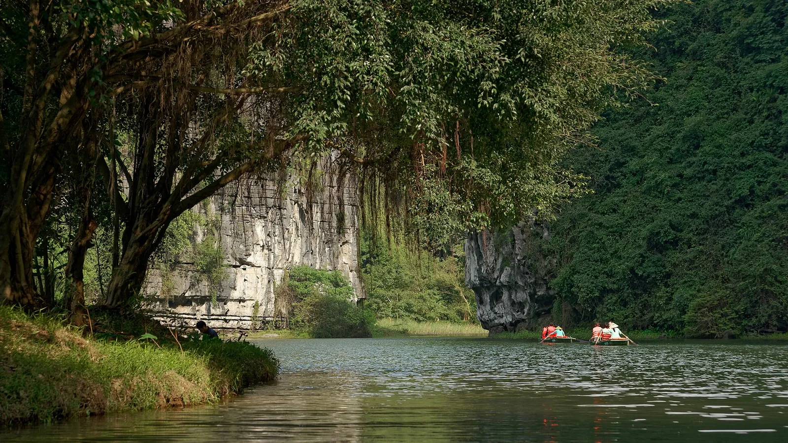 Limestone karst hills and a river at the Trang An Landscape Complex in Ninh Binh