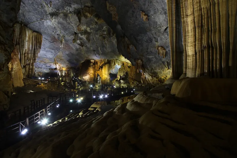 A wooden walkway through the vast chamber of Paradise Cave